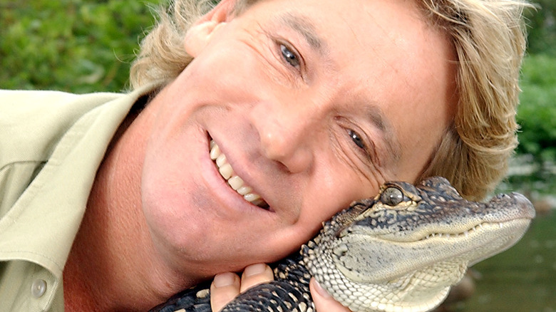 Steve Irwin poses with a crocodile