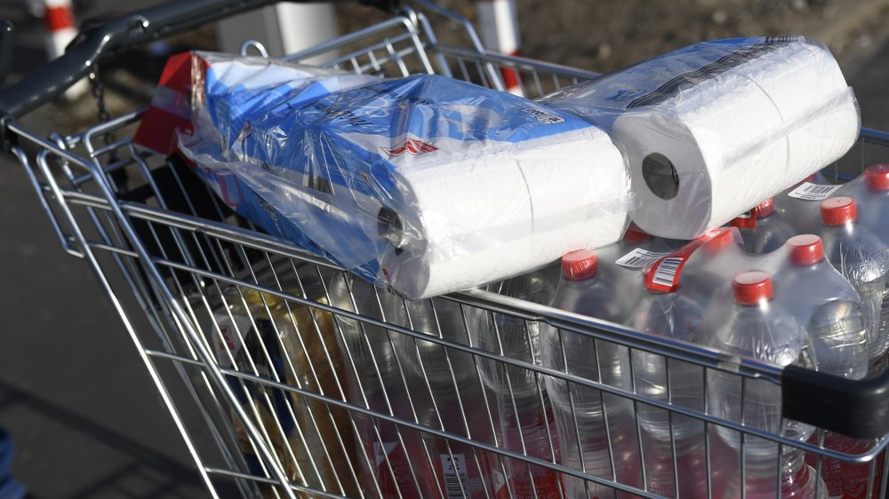 shopping cart of water and toilet paper