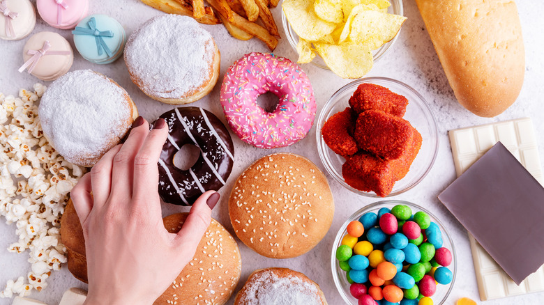 Person's hand reaching for junk food