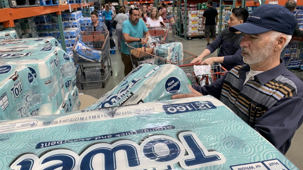 Shoppers checking out toilet paper and kitchen rolls