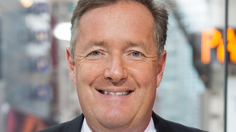 Piers Morgan smiles at an event.