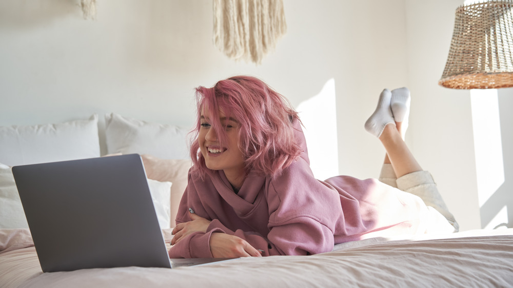 Person watching TV on their laptop