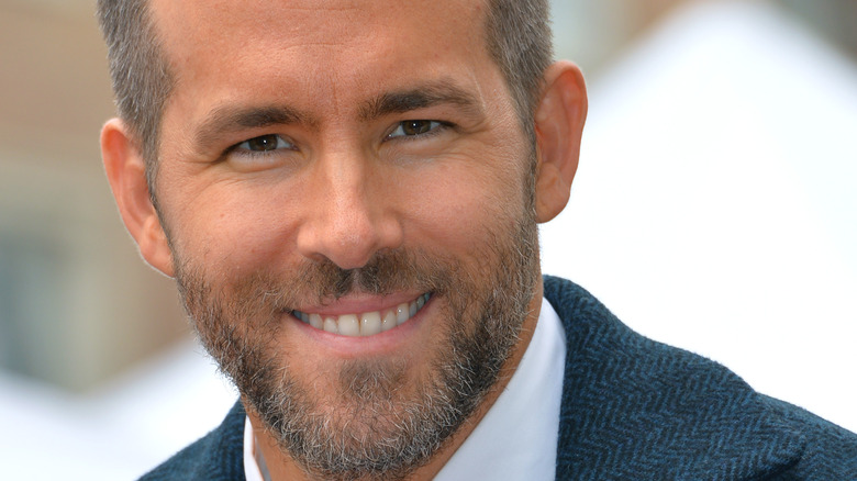 Ryan Reynolds smiling at event