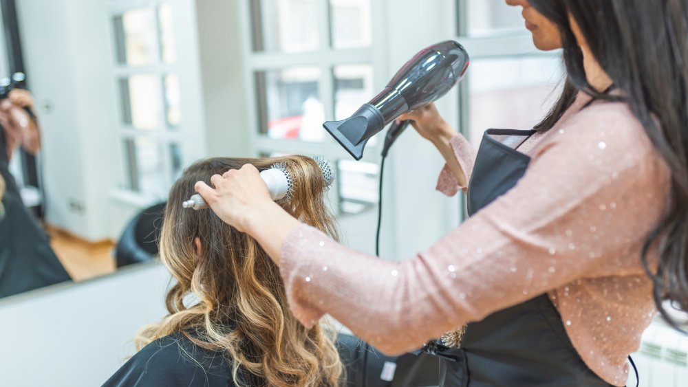 salon patron getting hair dried