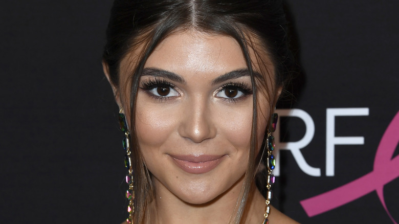 Olivia Jade smiles at an event