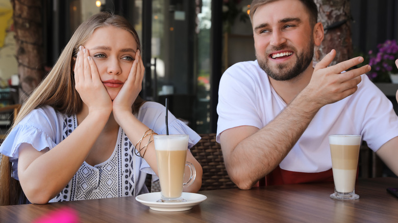 Bored woman listening to man 