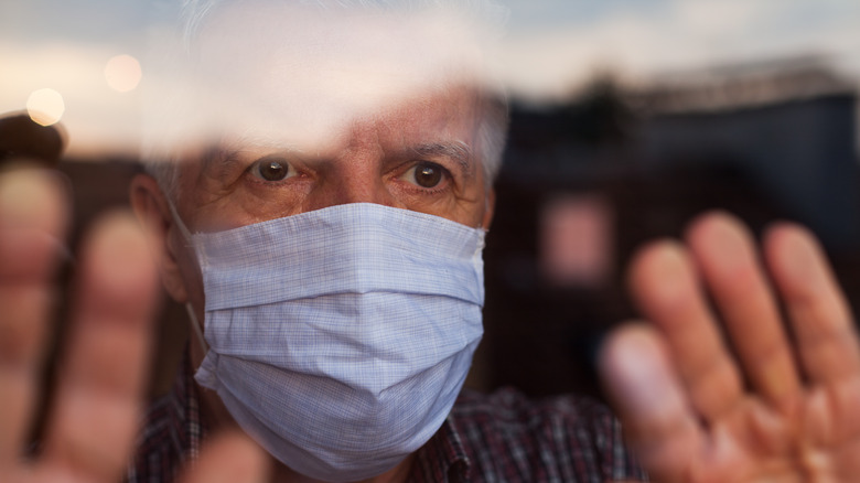 older man wearing face mask inside