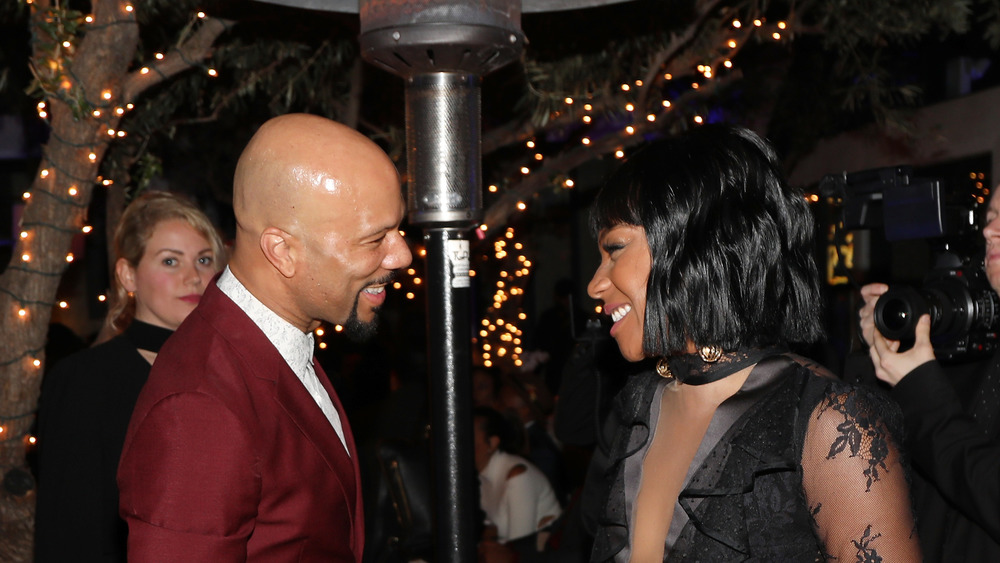 Tiffany Haddish and Common smile at each other