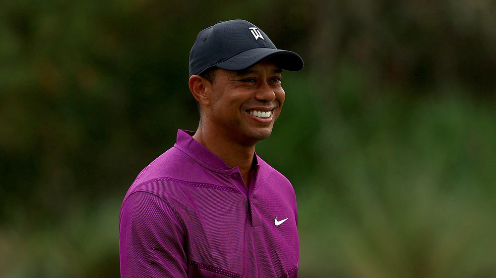 Tiger Woods smiling on the golf course