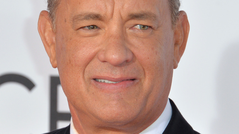 Tom Hanks smiles on the red carpet