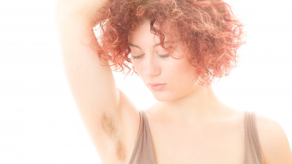 Woman showing armpit hair