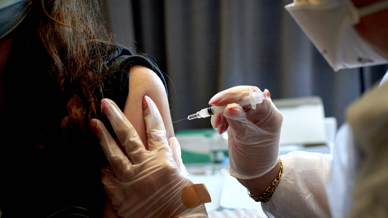 Doctor giving patient a needle