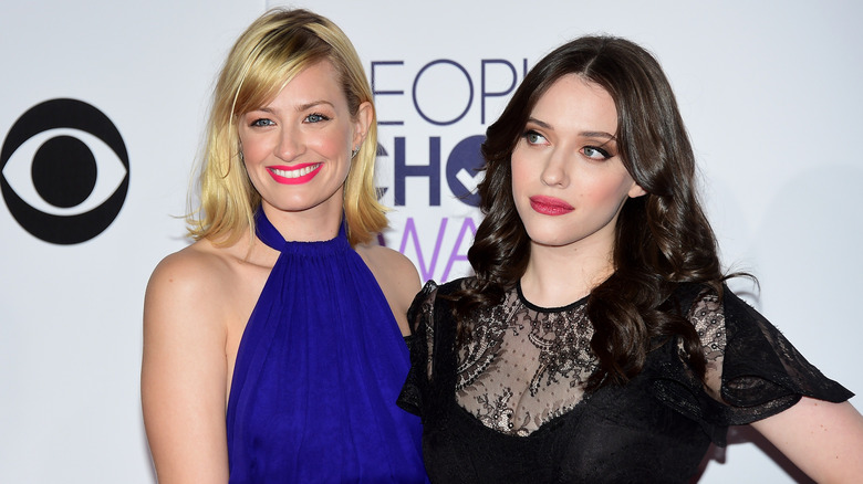 Beth Behrs and Kat Dennings posing together at an event