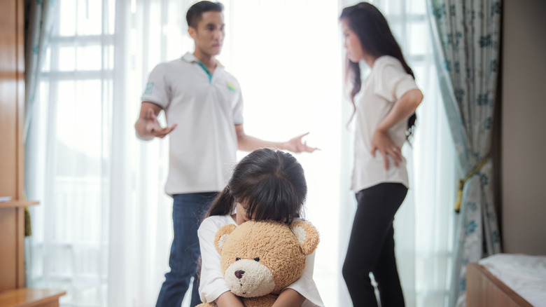 couple disagreeing in front of child