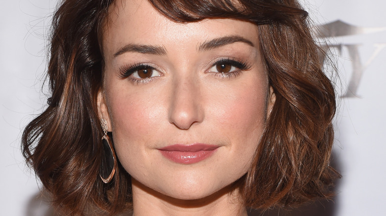 Milana Vayntrub slightly smiling