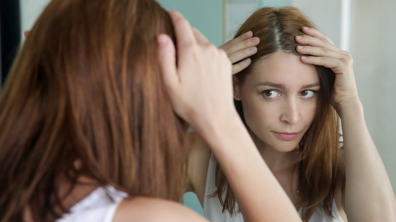 Woman looking at her scalp