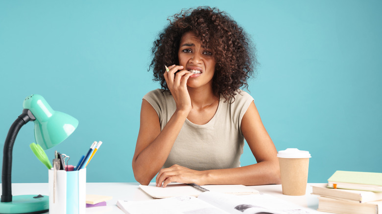 Woman biting nails