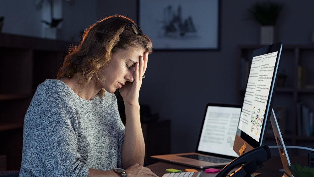 Woman staring at screen with a headache