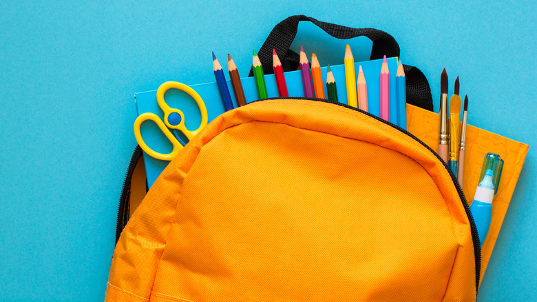 backpack and pencils on table