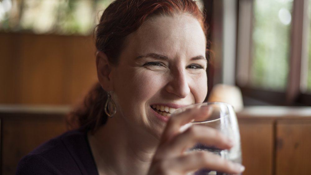 Woman in restaurant sipping water