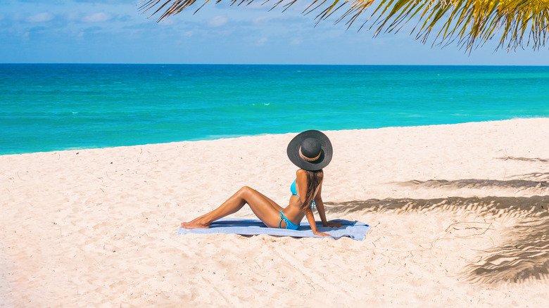 Woman sunbathing on an island