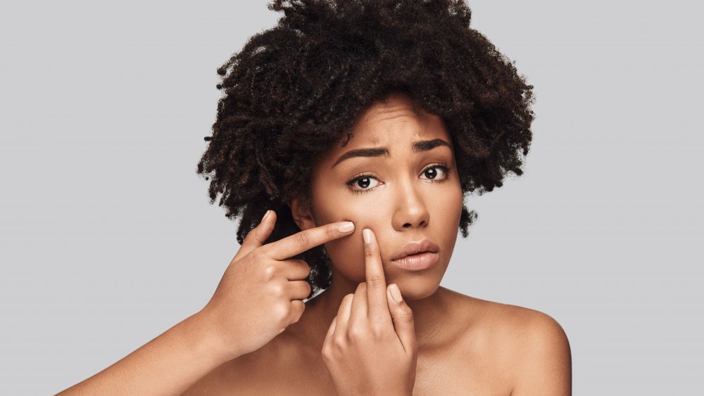 woman looking at acne