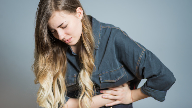 Young woman having rib pain