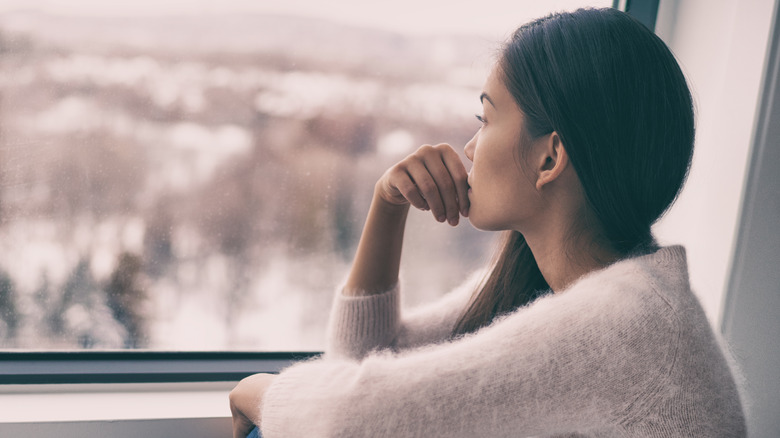 Woman looking out a window