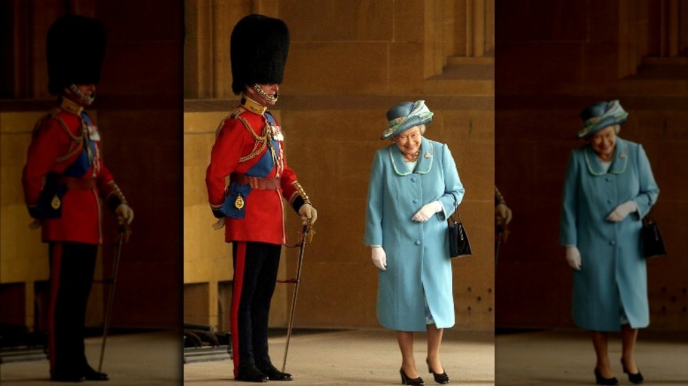 Queen Elizabeth laughing near Prince Philip