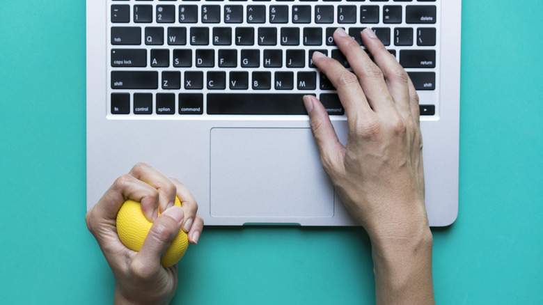 person squeezing a stress ball