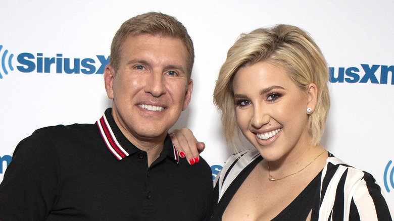 Savannah Chrisley poses with her father Todd at an event