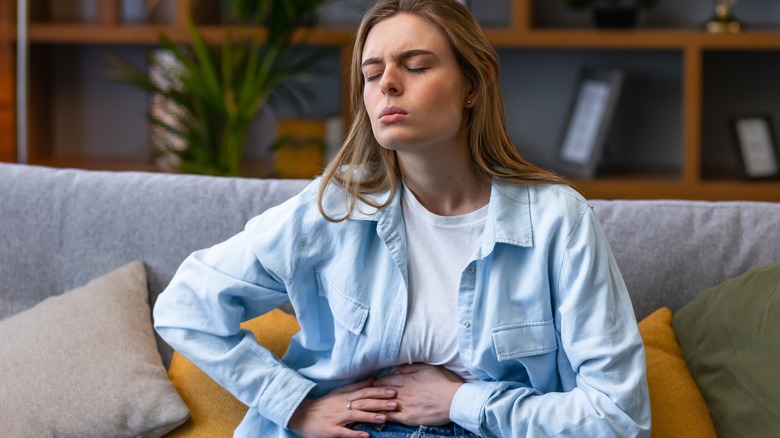 A woman clutching her stomach