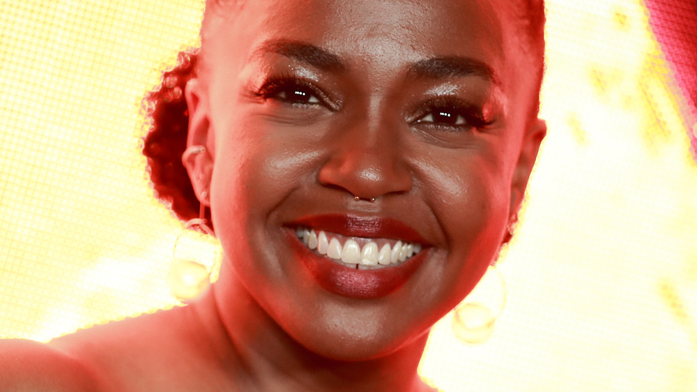 Jerrika Hinton smiling lit background