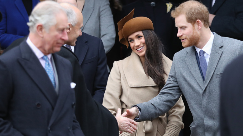 Meghan and Harry with Charles in the foreground 