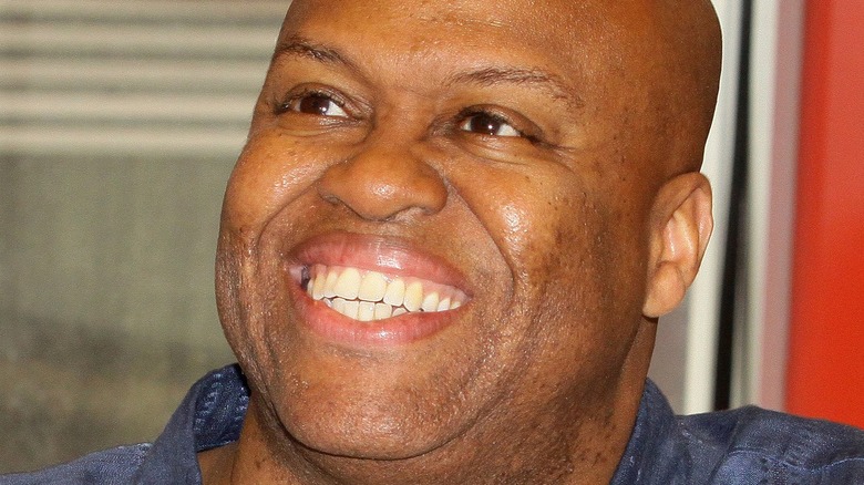 Michelle Obama's brother Craig Robinson smiling at a book signing