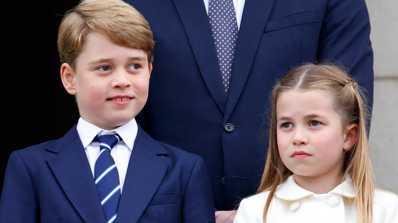 Prince George smiling slightly and Princess Charlotte looking serious