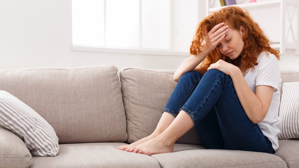 Redheaded woman on couch