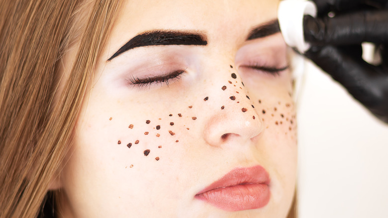 Woman with henna on eyebrows and cheeks 