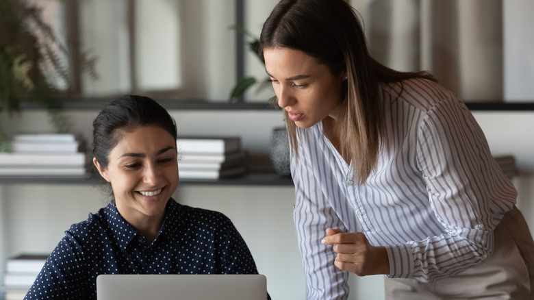 Two women working on laptop 