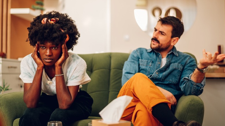 Man arguing with woman on couch