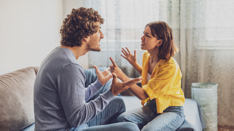 Couple arguing on the sofa
