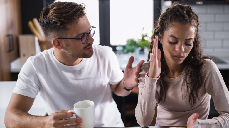 Couple arguing at kitchen table