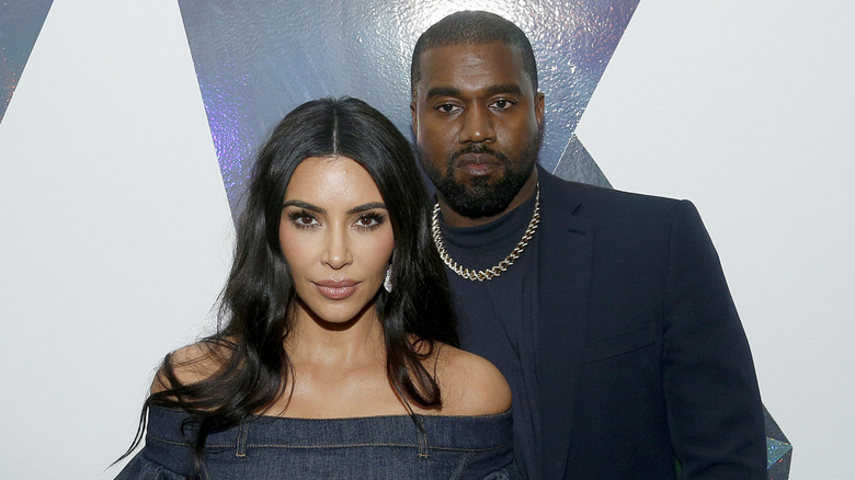 Kanye West stands behind Kim Kardashian