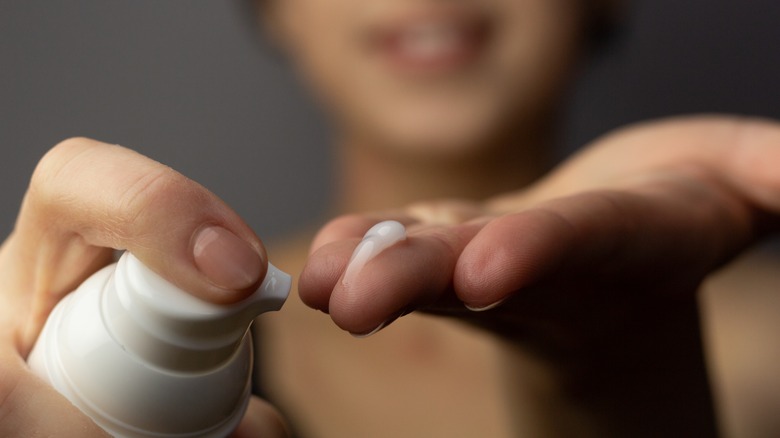 Woman applying retinol