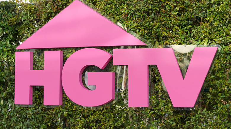 Pink HGTV on bush backdrop