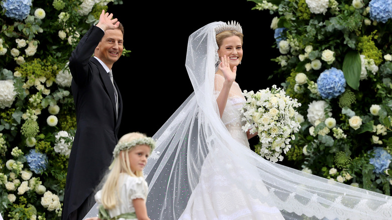 Alois, Hereditary Prince of Liechtenstein, and his daughter, Princess Marie Caroline of Liechtenstein waving outside church on her wedding day