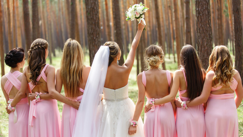 Bride with bridesmaids in forest