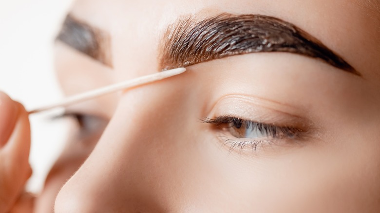 Applying wax on eyebrows