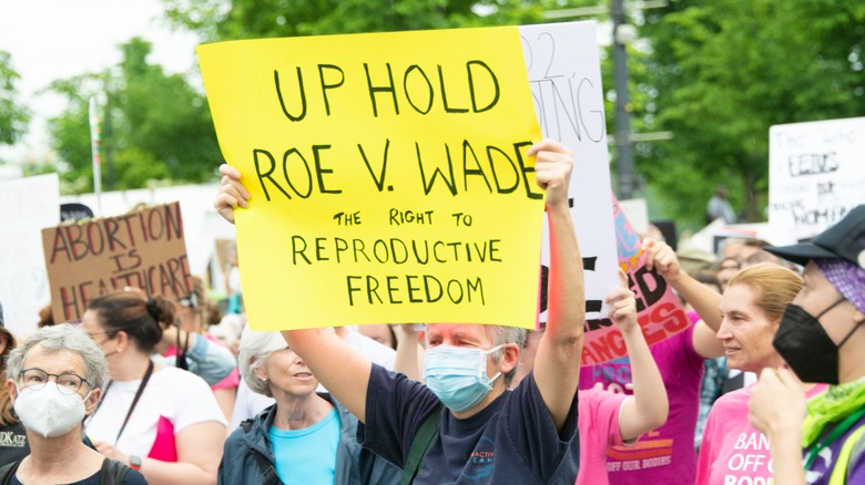 Protester holding a sign saying "UPHOLD ROE V. WADE"