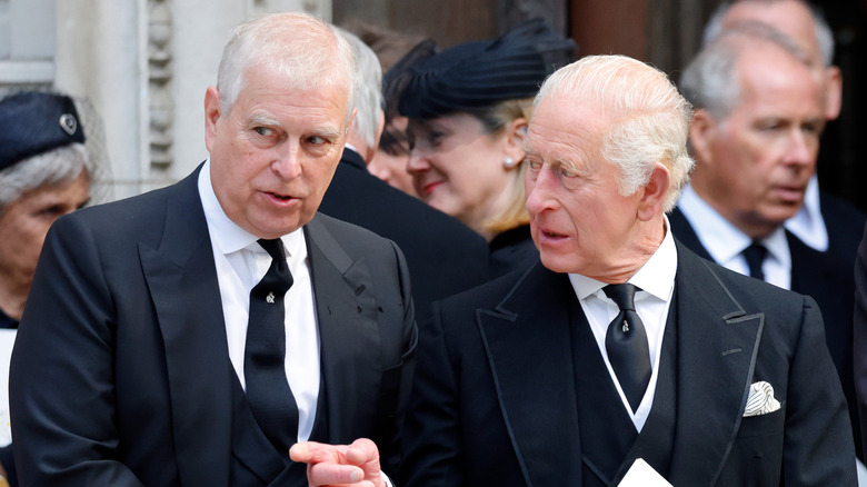 King Charles III talking to Andrew Mountbatten-Windsor